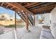 Covered backyard patio featuring a lounge and wooden stairs, offering an outdoor living space at 9307 Shadowglen Ct, Highlands Ranch, CO 80126