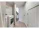 Efficient laundry area featuring a washer and dryer, storage shelves and tile floors at 9307 Shadowglen Ct, Highlands Ranch, CO 80126