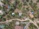 Expansive aerial view showcasing the property's serene setting among lush greenery and neighboring homes at 4786 Forest Hill Rd, Evergreen, CO 80439