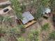 Aerial view of a home with a large deck surrounded by lush trees, offering privacy and tranquility at 4786 Forest Hill Rd, Evergreen, CO 80439
