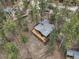 Aerial view of a home with a large deck nestled among lush trees, offering privacy and tranquility at 4786 Forest Hill Rd, Evergreen, CO 80439