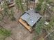 An aerial view of a well-maintained home surrounded by tall trees at 4786 Forest Hill Rd, Evergreen, CO 80439
