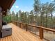 Expansive back deck overlooking a picturesque forest view that creates a calm and inviting outdoor space at 4786 Forest Hill Rd, Evergreen, CO 80439