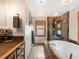 Modern bathroom with a soaking tub, walk-in shower, wood cabinets, and a rustic vanity at 4786 Forest Hill Rd, Evergreen, CO 80439