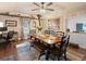 Bright dining room with wood paneled walls, ceiling fan and rustic dining set at 4786 Forest Hill Rd, Evergreen, CO 80439