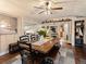 Bright dining room with wood paneled walls and rustic dining set leading into the kitchen at 4786 Forest Hill Rd, Evergreen, CO 80439