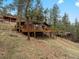Secluded home with a spacious wraparound deck providing stunning views of the surrounding landscape at 4786 Forest Hill Rd, Evergreen, CO 80439