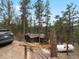 Exterior of a house nestled in a wooded area, featuring a welcoming entrance, stairs, and lush natural surroundings at 4786 Forest Hill Rd, Evergreen, CO 80439