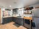 Updated kitchen featuring dark cabinets, stainless steel appliances, and beautiful tile flooring at 4786 Forest Hill Rd, Evergreen, CO 80439