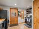 Bright kitchen with stainless steel appliances, wood countertops, and tiled flooring at 4786 Forest Hill Rd, Evergreen, CO 80439