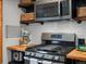 Updated kitchen featuring stainless steel appliances and butcher block countertops at 4786 Forest Hill Rd, Evergreen, CO 80439
