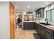 Renovated kitchen with black cabinets, stainless sink, and access to an office at 4786 Forest Hill Rd, Evergreen, CO 80439