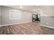 Finished basement with laminate floors, recessed lights, and natural light window at 5311 S Danube Ct, Centennial, CO 80015