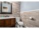 Charming half bathroom with wood paneling, updated vanity, and modern fixtures at 5311 S Danube Ct, Centennial, CO 80015