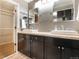Modern bathroom with dual sinks, dark wood cabinets, and stylish fixtures at 5311 S Danube Ct, Centennial, CO 80015