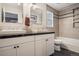 Bathroom featuring double sinks, tiled walls and floors, and modern fixtures at 5311 S Danube Ct, Centennial, CO 80015