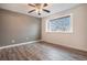 Serene bedroom with plank floors, ceiling fan, large window, and neutral decor at 5311 S Danube Ct, Centennial, CO 80015