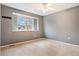 Neutral bedroom features plush carpeting, a ceiling fan, and a sunny window at 5311 S Danube Ct, Centennial, CO 80015