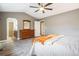 Bright bedroom with connecting bath featuring plank floors, ceiling fan, and neutral tones at 5311 S Danube Ct, Centennial, CO 80015