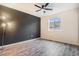 Stylish bedroom features sleek laminate flooring, a modern fan and a large window at 5311 S Danube Ct, Centennial, CO 80015
