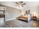 Comfortable bedroom featuring plank floors, a ceiling fan, and neutral tones at 5311 S Danube Ct, Centennial, CO 80015
