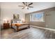 Inviting bedroom with neutral colors, plank flooring, and a bright window at 5311 S Danube Ct, Centennial, CO 80015