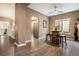 Cozy dining area with dark wood floors, unique barrel table, and ample natural light at 5311 S Danube Ct, Centennial, CO 80015