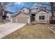Charming two-story home featuring a two-car garage, stone accents and a well-manicured lawn at 5311 S Danube Ct, Centennial, CO 80015