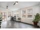 Bright sunroom with white shiplap walls, gray floors, and multiple windows at 5311 S Danube Ct, Centennial, CO 80015
