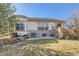 A backyard offers an inviting stone patio, perfect for outdoor relaxation at 16494 Aliante Dr, Broomfield, CO 80023