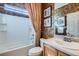 Bathroom featuring a shower-tub, framed art, and warm neutral tones at 16494 Aliante Dr, Broomfield, CO 80023