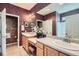 Bathroom with double sink vanity, large mirror, tiled flooring and shower over bath at 16494 Aliante Dr, Broomfield, CO 80023