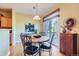 Dining area features hardwood flooring, table with chairs, sliding glass doors and natural light at 16494 Aliante Dr, Broomfield, CO 80023