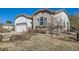 A close-up view of the property showing the stone and stucco exterior details and attractive landscaping at 16494 Aliante Dr, Broomfield, CO 80023