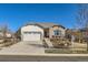 Charming single-story home featuring a stone facade and well-manicured front yard, perfect for curb appeal at 16494 Aliante Dr, Broomfield, CO 80023