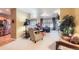 Open-concept living room featuring neutral colors, fireplace, and large windows that provide ample natural light at 16494 Aliante Dr, Broomfield, CO 80023