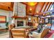 Inviting lobby with a stone fireplace, vaulted ceilings, wood beams, and comfortable seating at 16494 Aliante Dr, Broomfield, CO 80023