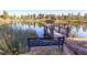 Picturesque pond view with a charming pier and bench seating at 16494 Aliante Dr, Broomfield, CO 80023