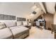 Bright bonus room with a vaulted ceiling, and a dedicated workspace with a computer setup at 814 S Vance St # F, Lakewood, CO 80226