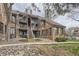 Brick condo building featuring multiple balconies, with stairs leading to the units at 814 S Vance St # F, Lakewood, CO 80226