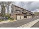 Charming townhome complex featuring private garages, balconies, and brick and wood exterior finishes at 814 S Vance St # F, Lakewood, CO 80226