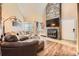 Cozy living room with a stone fireplace, wood floors, and a comfortable couch at 814 S Vance St # F, Lakewood, CO 80226