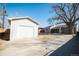 Detached garage and fenced yard provide privacy to this well-maintained home's exterior at 6671 Oneida St, Commerce City, CO 80022