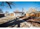 View of backyard with new fence, shed, and blue skies at 6671 Oneida St, Commerce City, CO 80022