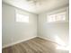 Well-lit bedroom with two windows and modern flooring at 6671 Oneida St, Commerce City, CO 80022