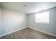 This bedroom includes hardwood floors and a bright window at 6671 Oneida St, Commerce City, CO 80022