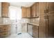 Bright kitchen features wooden cabinets, granite countertops, stainless steel appliances, and tile backsplash at 6671 Oneida St, Commerce City, CO 80022