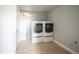 Clean laundry room features a side-by-side washer and dryer set and neutral color scheme at 6671 Oneida St, Commerce City, CO 80022