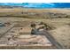 Aerial view of the property, featuring the house, barn, surrounding land, and driveway at 11549 Haskell Creek Rd, Larkspur, CO 80118