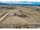 Overhead shot showcasing the house, barn, and acreage in a serene, rural setting with mountain views at 11549 Haskell Creek Rd, Larkspur, CO 80118